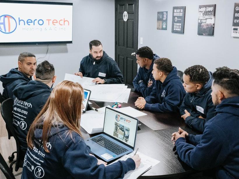 The Hero Tech Heating & A/C team planning the week's jobs at their Marlborough office